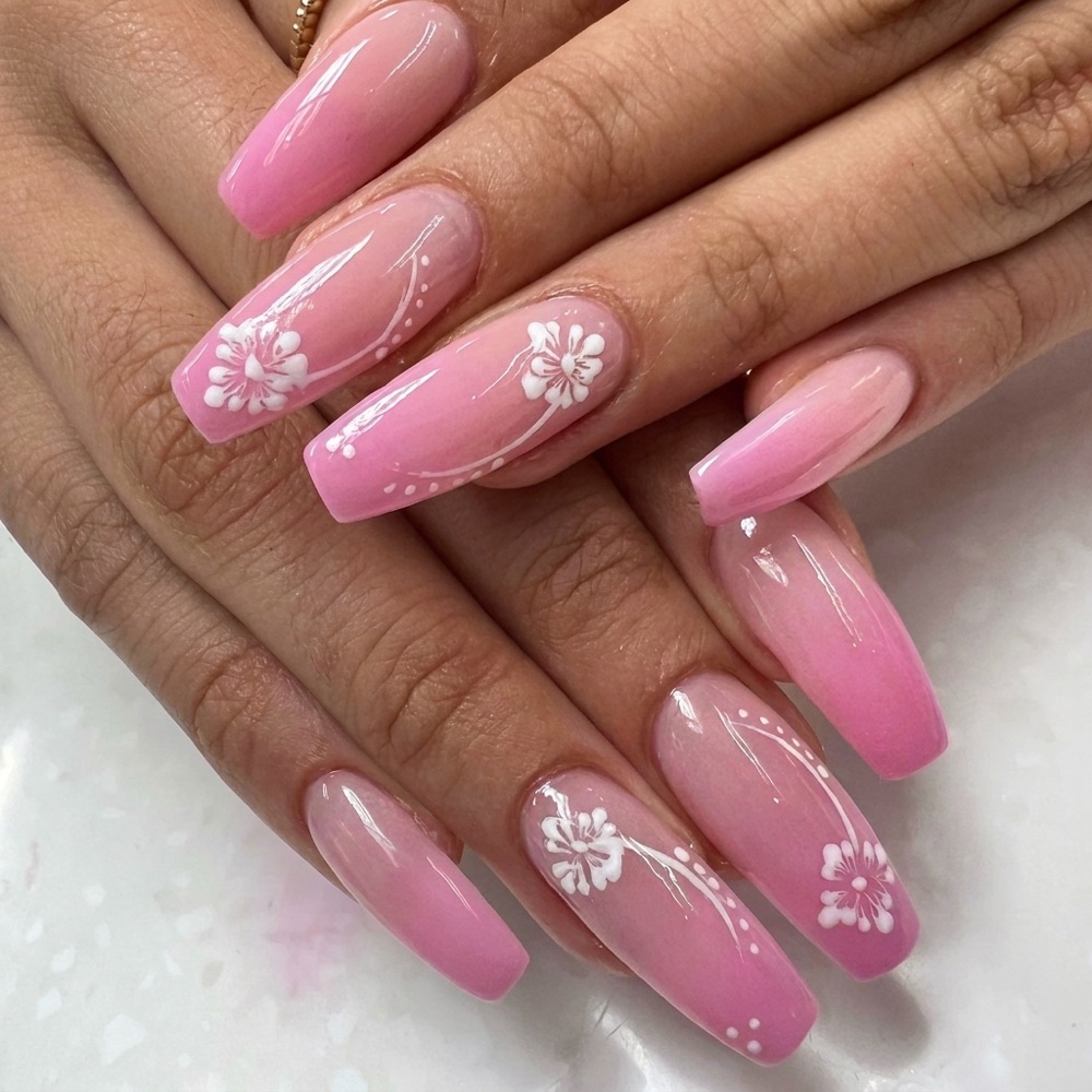 Long coffin nails in pink ombré with hand-painted white hibiscus flowers